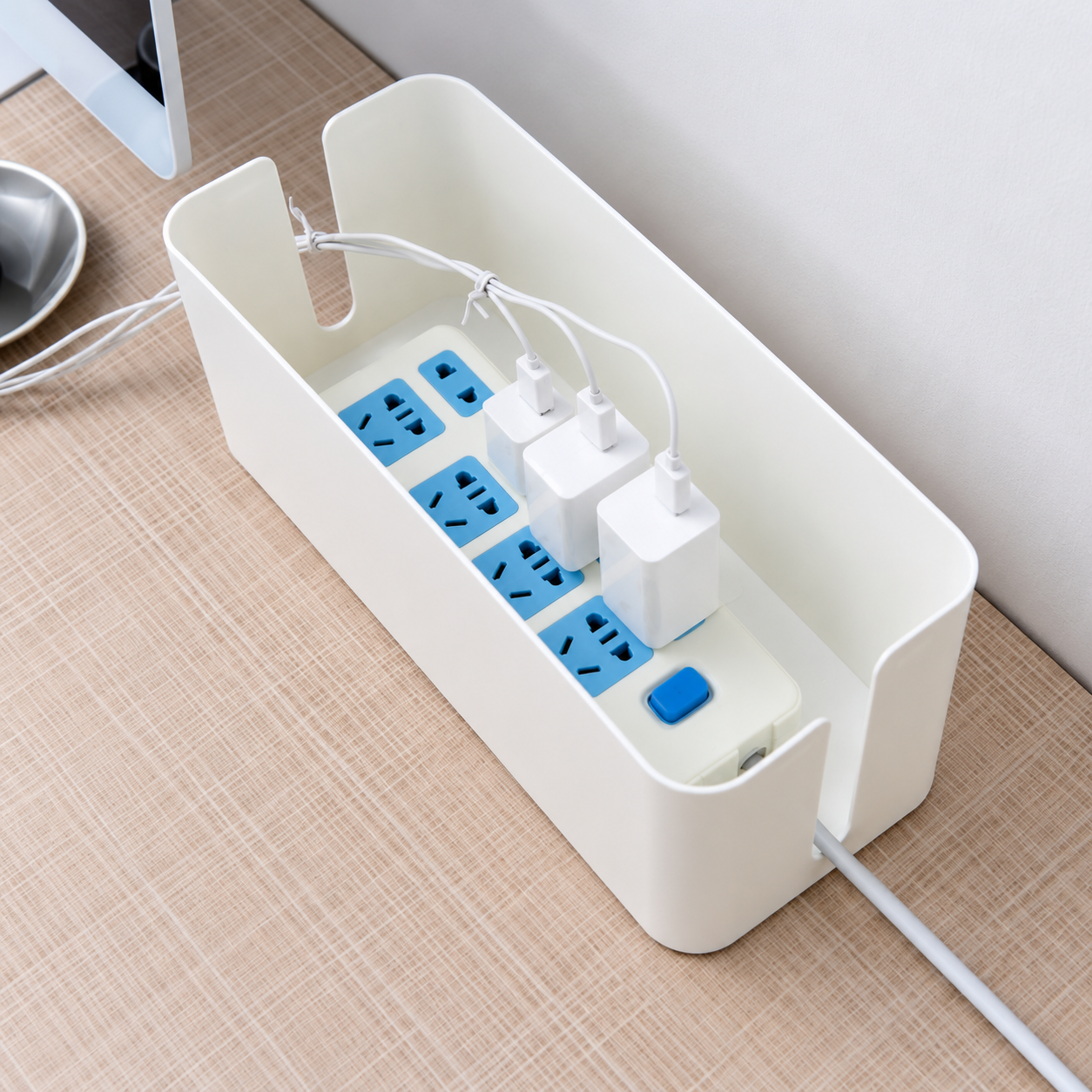 Retouched open white cable-box scene with a power strip, adapters and cables as props
